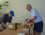 Matt Roney and Lester Brown unloading boxes of Full Planet, Empty Plates.